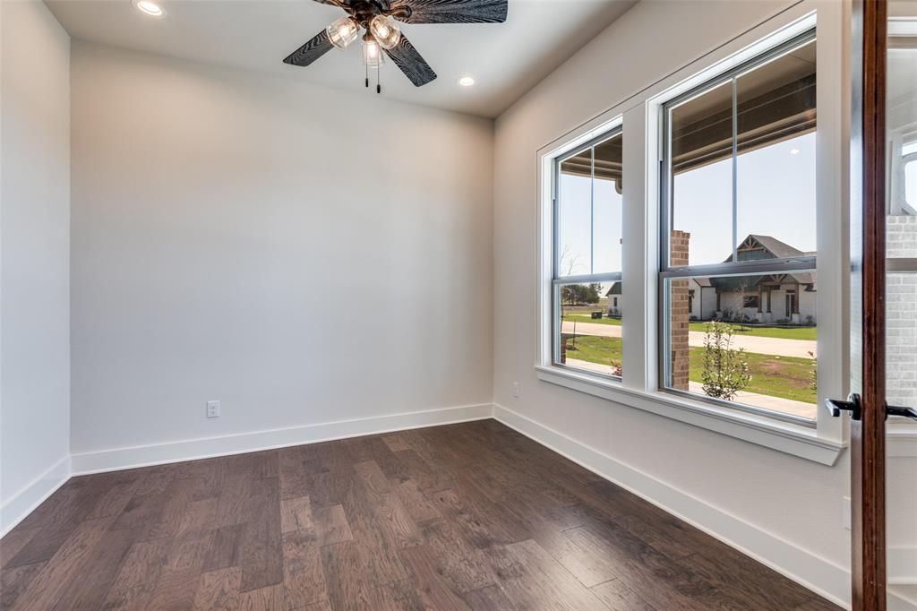 815 Evergreen Way Nevada, TX 75173 - Photo 27 of 38 a view of an empty room with a window and wooden floor