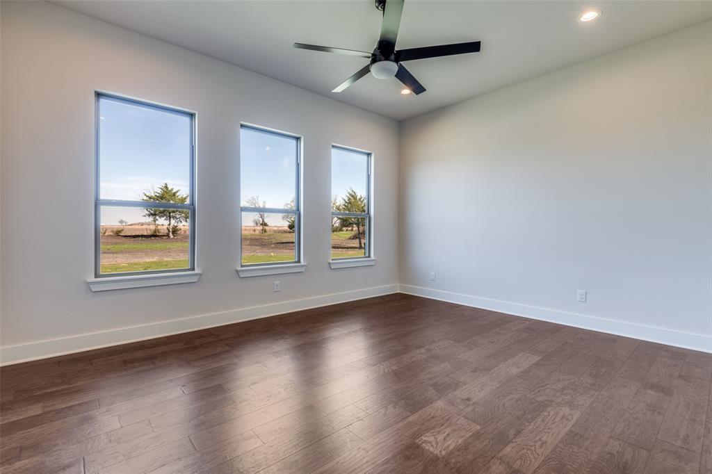 815 Evergreen Way Nevada, TX 75173 - Photo 29 of 38 a view of an empty room with window and wooden floor