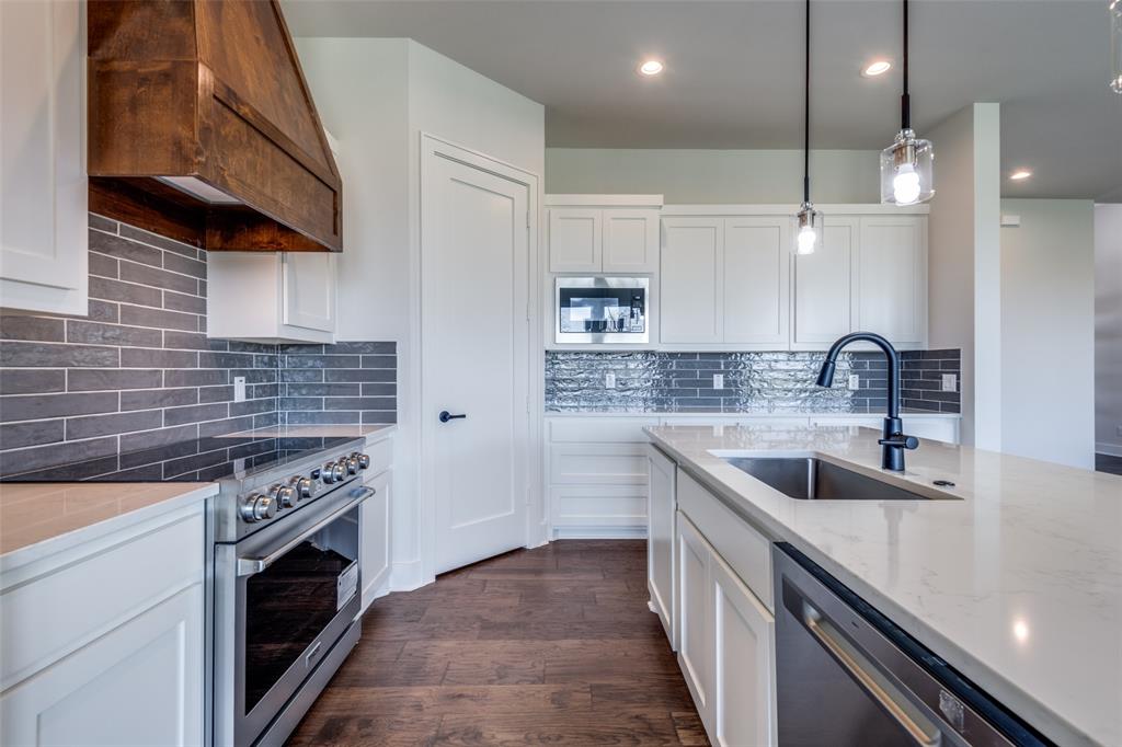815 Evergreen Way Nevada, TX 75173 - Photo 5 of 38 a kitchen with a sink stove top oven and cabinets
