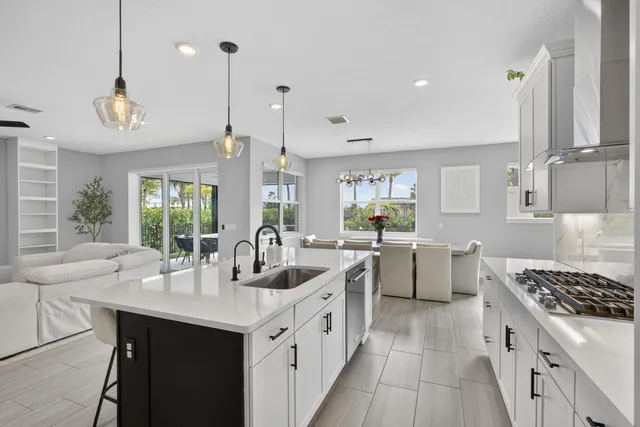 a kitchen with stove a sink and dishwasher with wooden floor