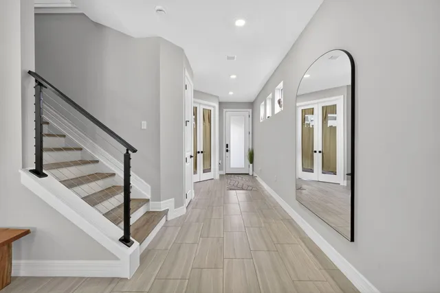 a view of a hallway view with wooden floor and staircase