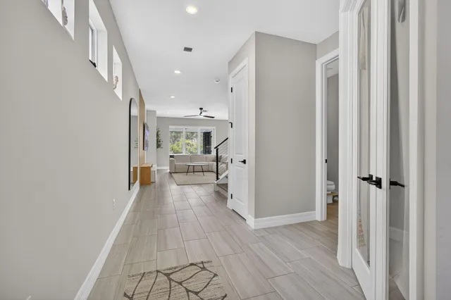 a view of a hallway view with wooden floor and staircase