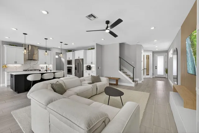 a living room with furniture and kitchen view