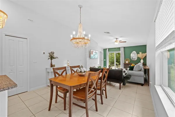 a living room with furniture a chandelier and a window