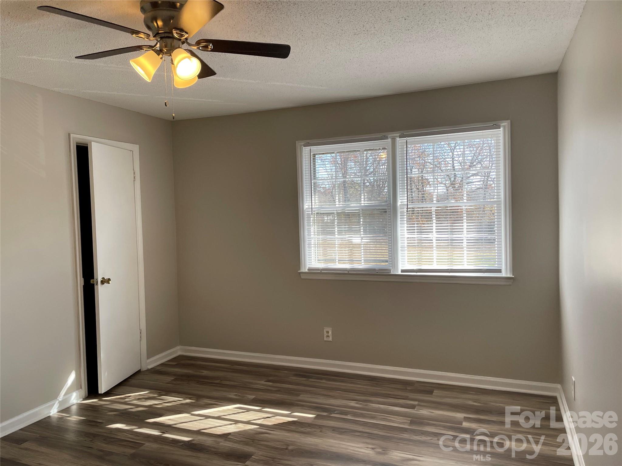 118 Ross Street, Unit B2 Morganton, NC 28655 - Photo 11 of 19 a view of an empty room with window and wooden floor