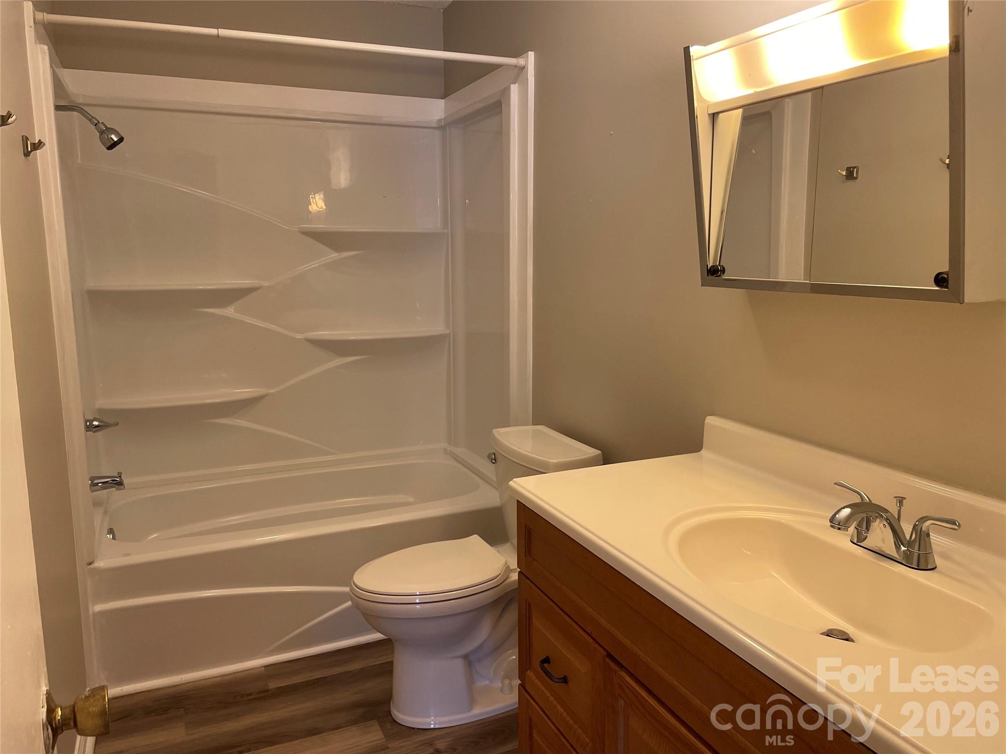 118 Ross Street, Unit B2 Morganton, NC 28655 - Photo 15 of 19 a bathroom with a sink toilet and shower