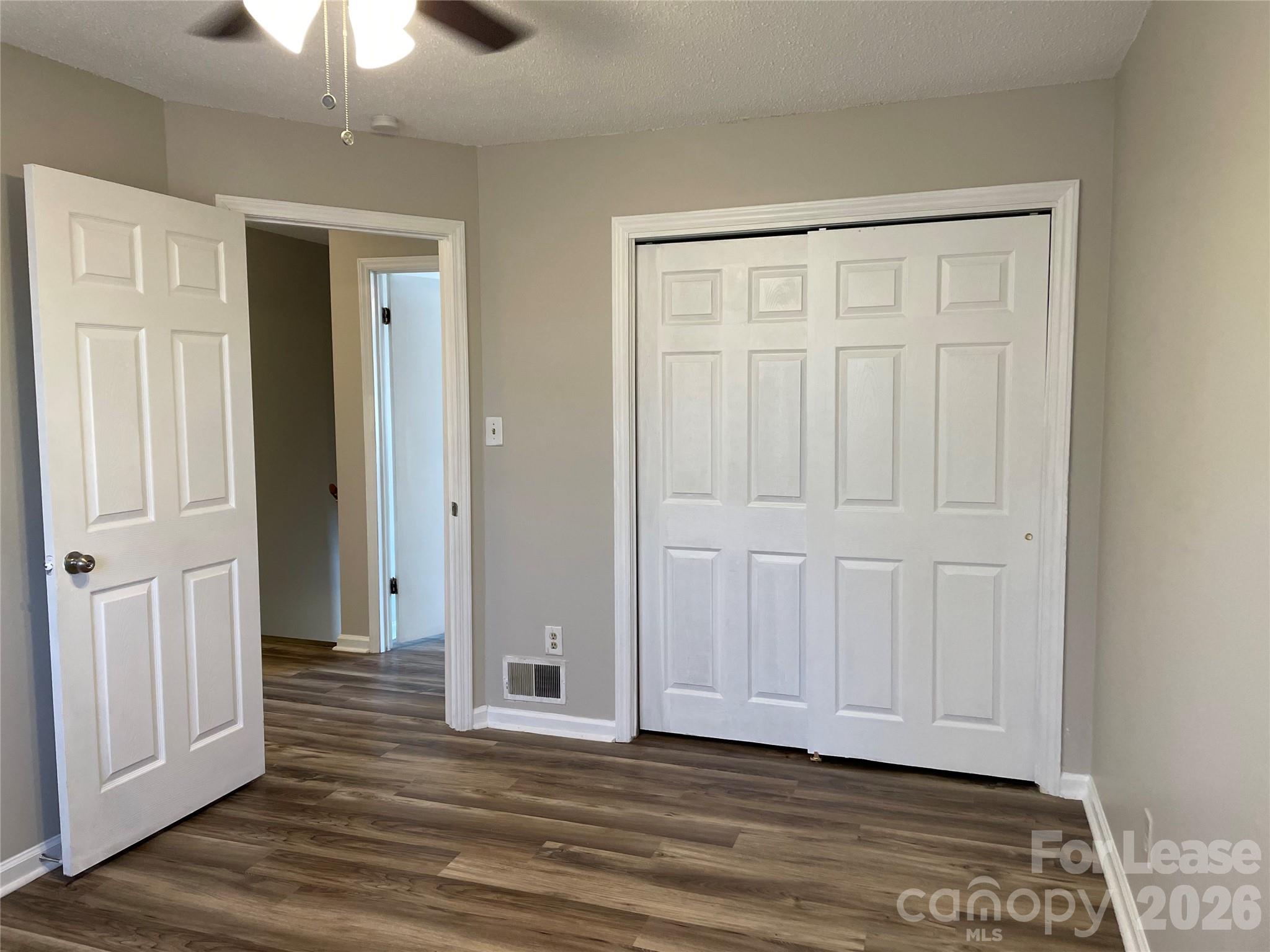 118 Ross Street, Unit B2 Morganton, NC 28655 - Photo 17 of 19 an empty room with wooden floor closet and windows