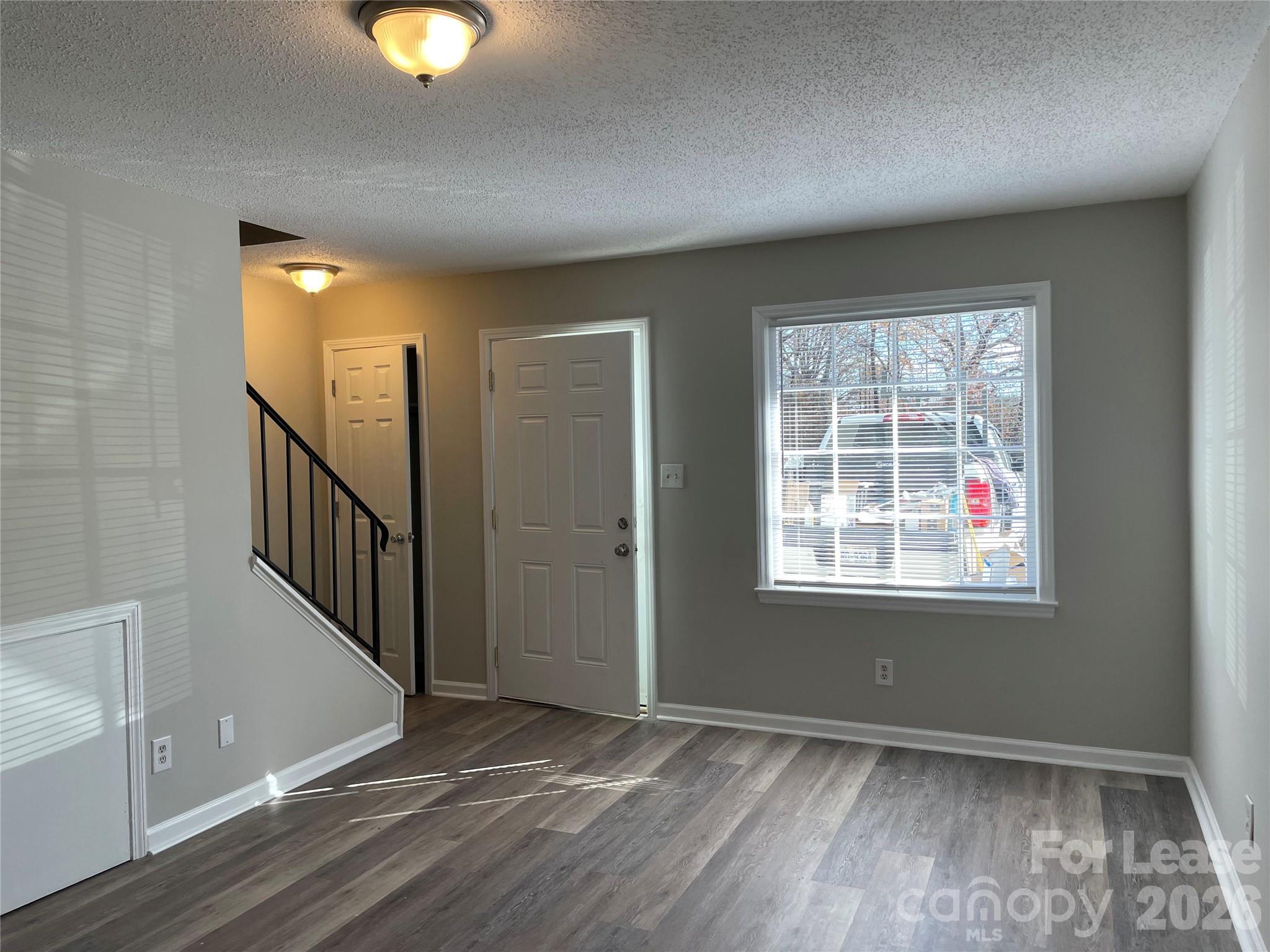 118 Ross Street, Unit B2 Morganton, NC 28655 - Photo 2 of 19 an empty room with wooden floor and windows