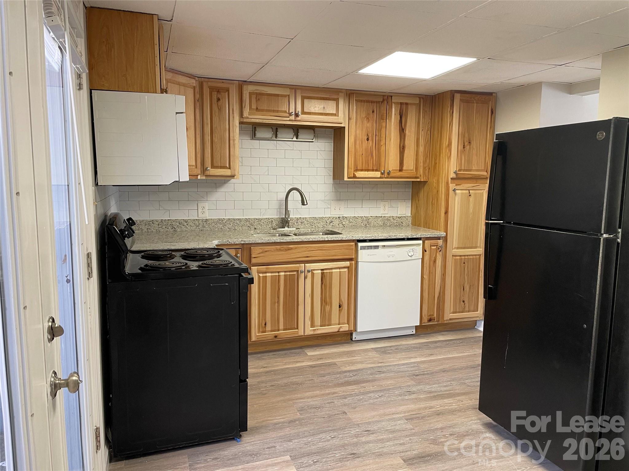118 Ross Street, Unit B2 Morganton, NC 28655 - Photo 7 of 19 a kitchen with a refrigerator and a sink