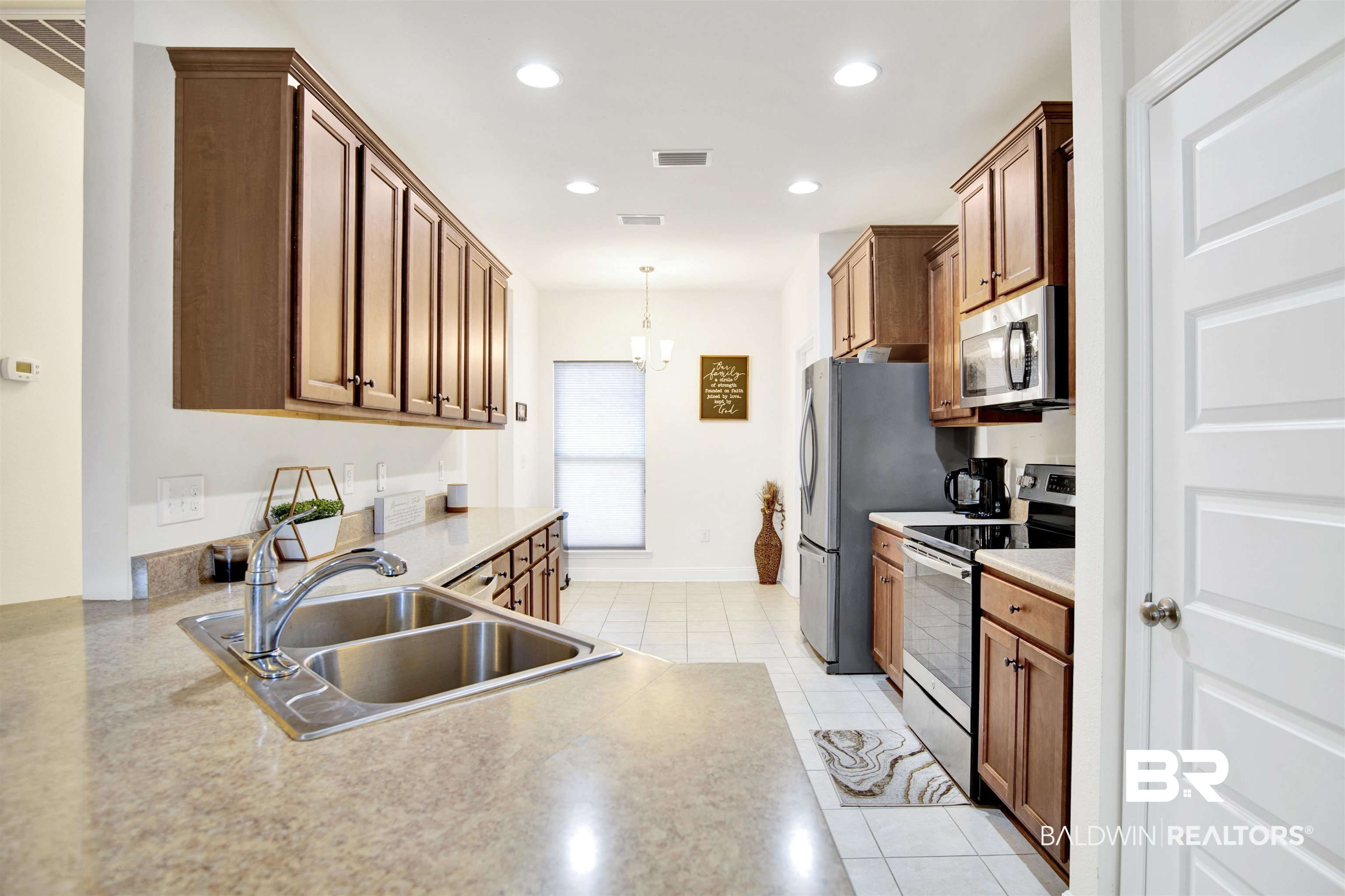 1468 Surrey Loop Foley, AL 36535 - Photo 11 of 28 Kitchen with stainless steel appliances, a sink, light tile patterned floors, hanging light fixtures, and recessed lighting