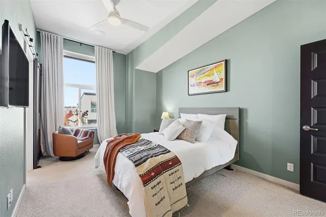 a bedroom with bed and glass door