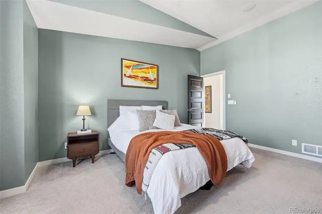 a bedroom with a bed and a lamp