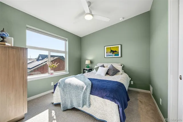 a bedroom with a bed and a painting on the wall