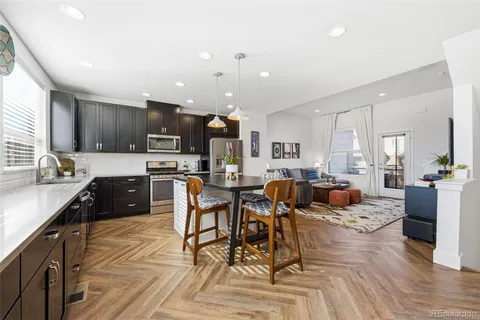 a large kitchen with a table and chairs