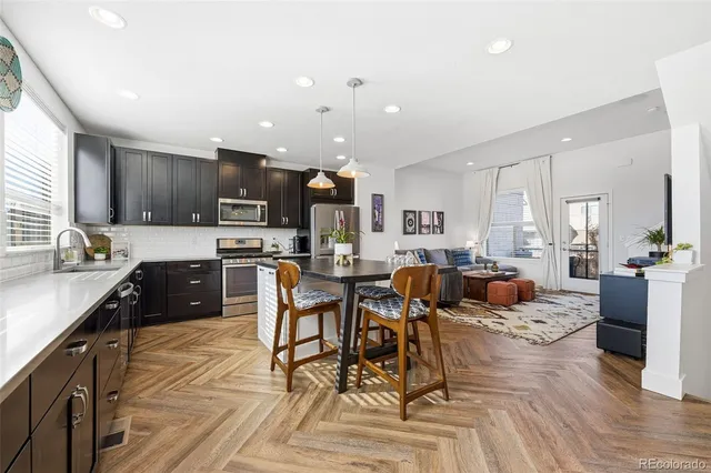a large kitchen with a table and chairs