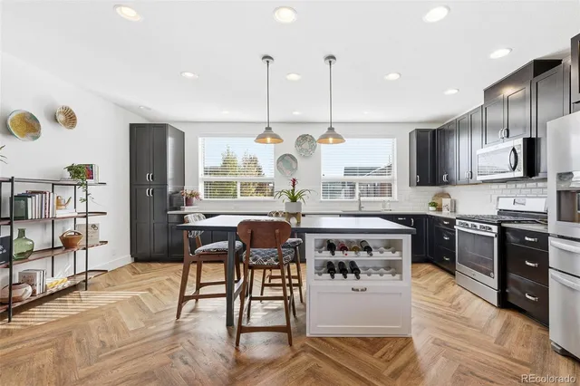 a large kitchen with a table and chairs in it