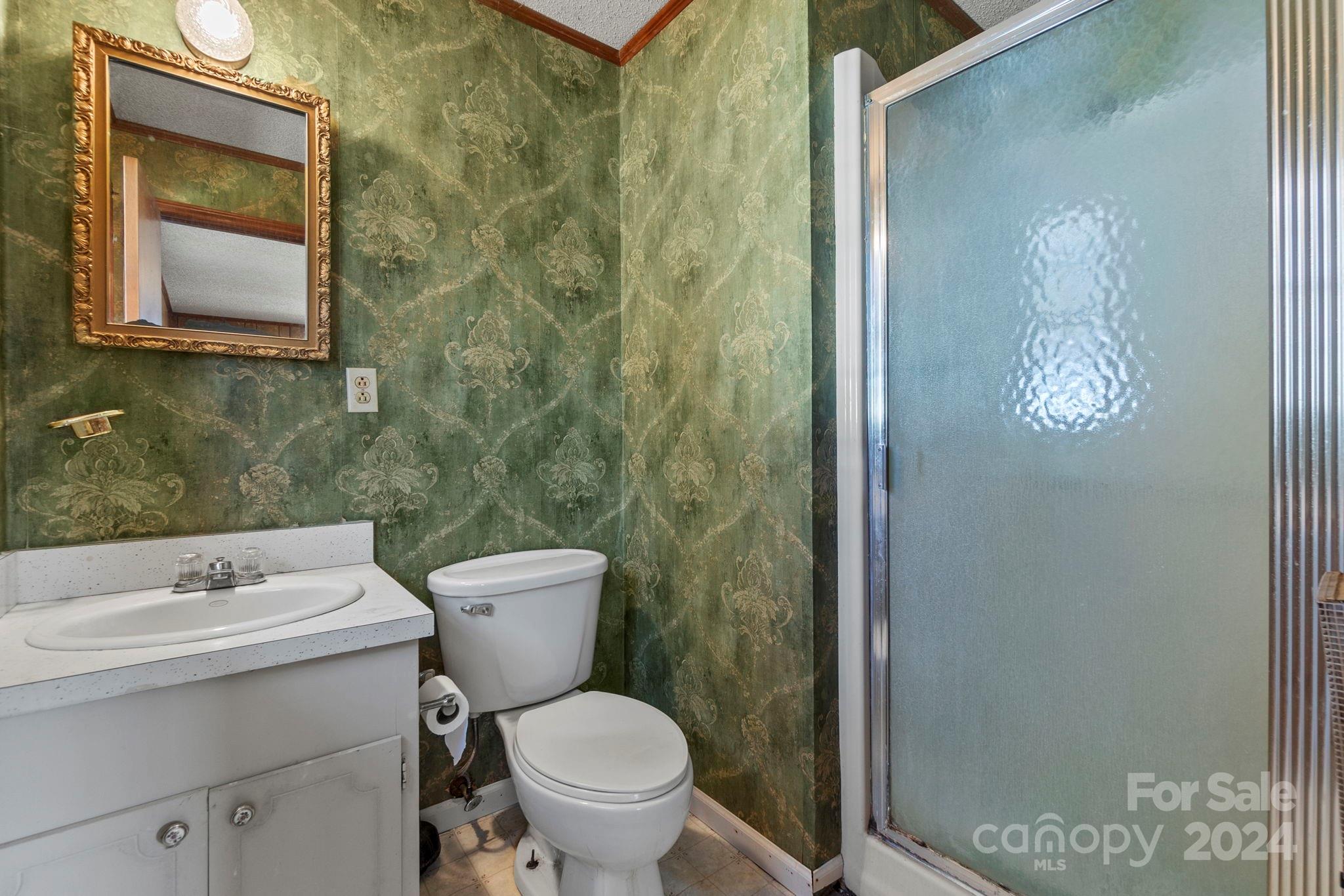 9813 Machado Drive Indian Trail, NC 28079 - Photo 13 of 27 a bathroom with a toilet sink and mirror