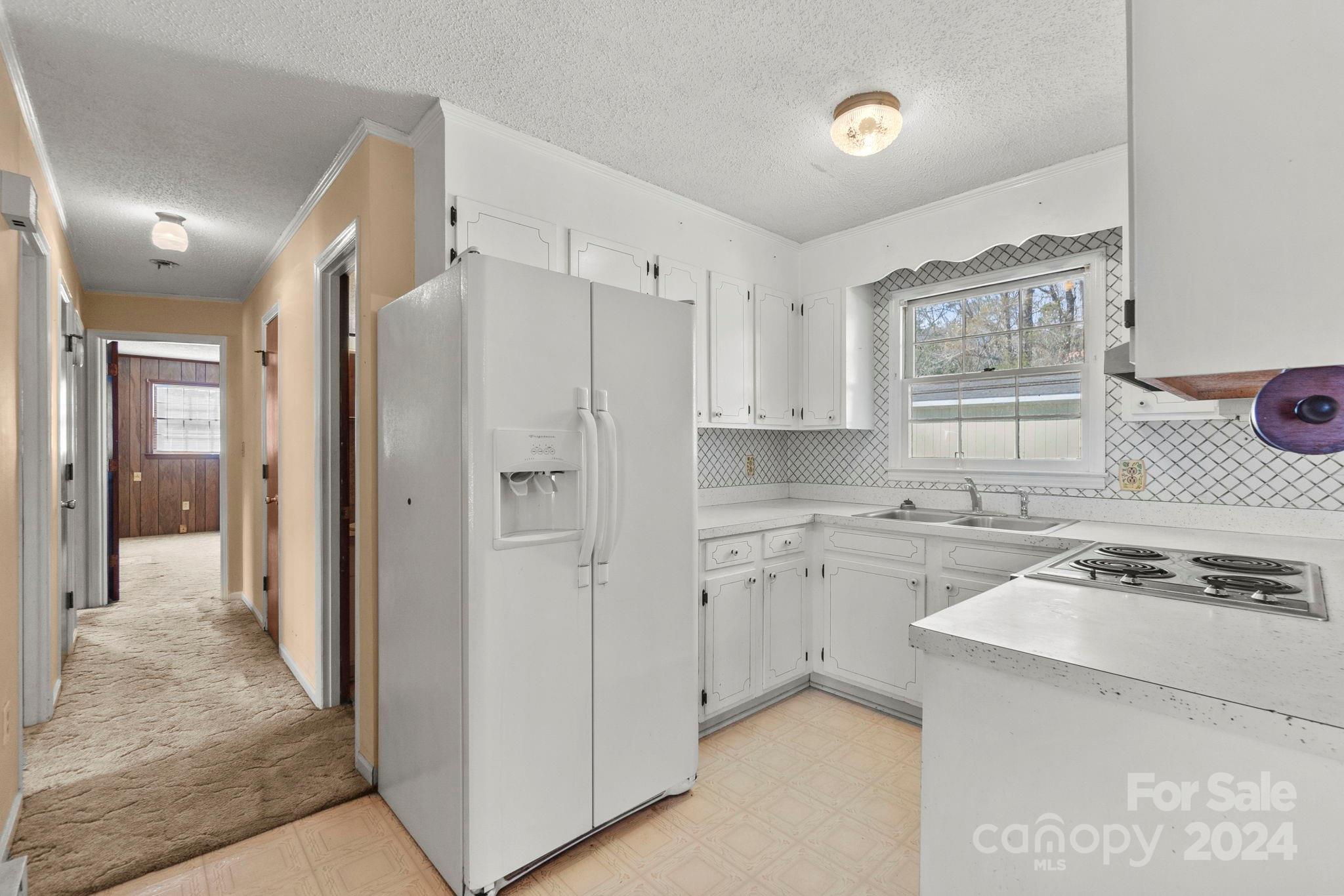 9813 Machado Drive Indian Trail, NC 28079 - Photo 2 of 27 a kitchen with cabinets and stainless steel appliances