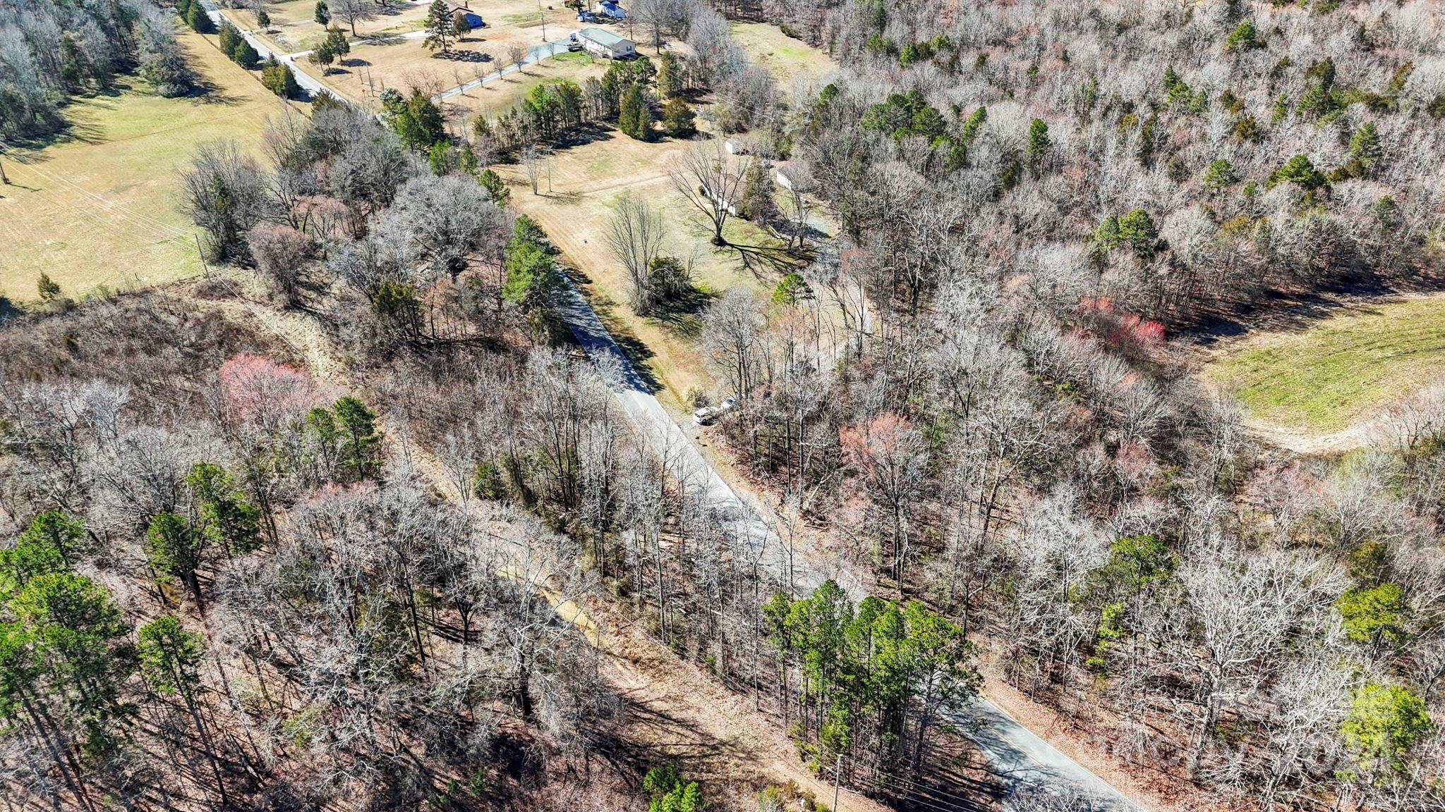 9813 Machado Drive Indian Trail, NC 28079 - Photo 23 of 27 a view of a house with a forest