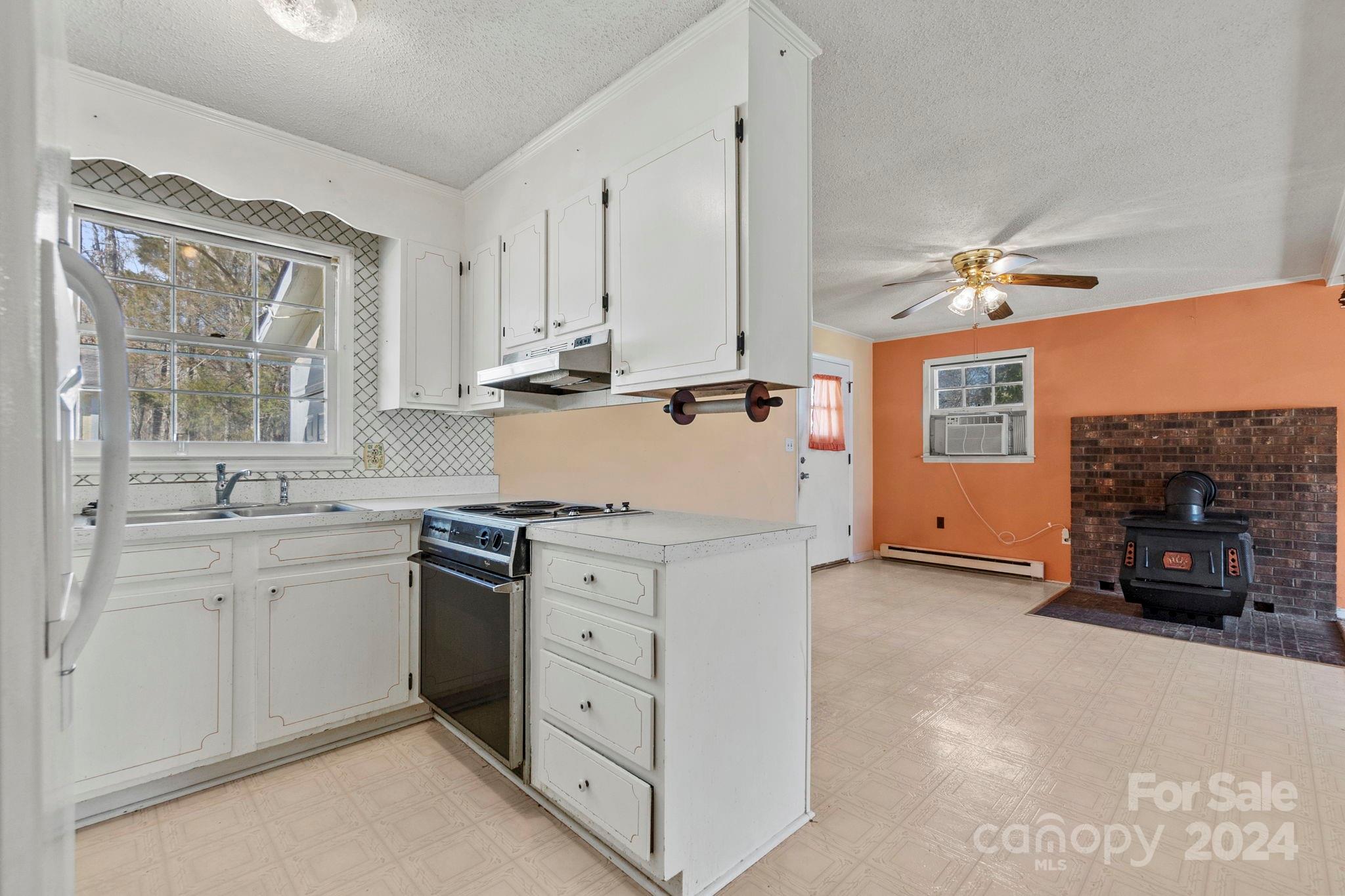 9813 Machado Drive Indian Trail, NC 28079 - Photo 4 of 27 a kitchen with cabinets appliances and a window