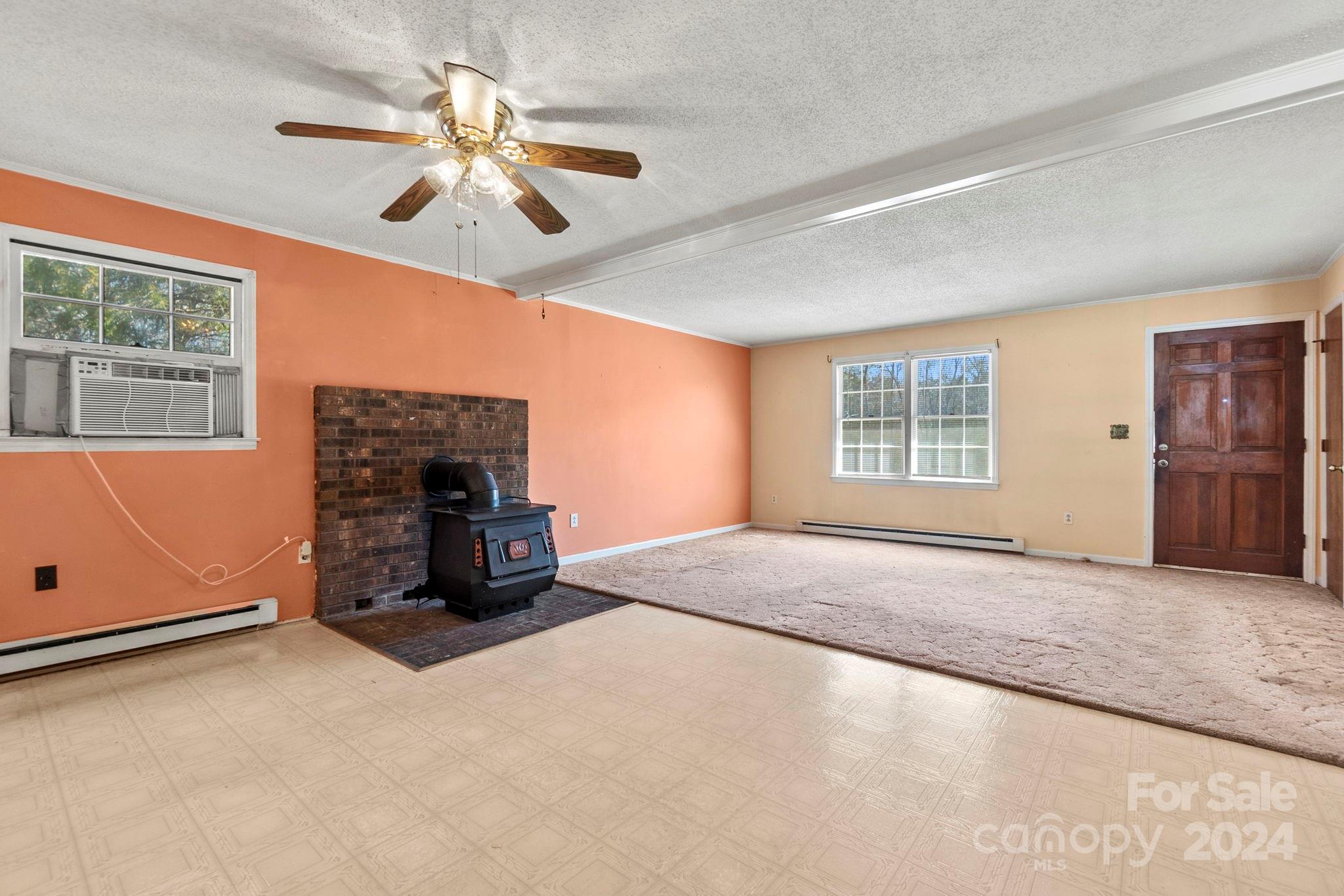 9813 Machado Drive Indian Trail, NC 28079 - Photo 7 of 27 a view of an empty room with a fireplace and a window