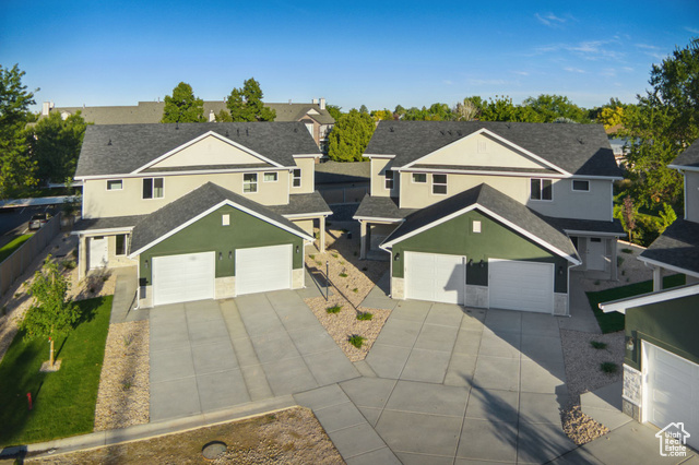 1615 North Angel Street, Unit H Layton, UT 84041 - Photo 35 of 55 Traditional-style home with a residential view, stucco siding, a garage, driveway, and roof with shingles