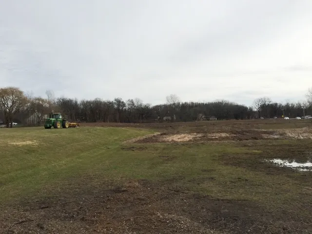 a view of field with trees in background
