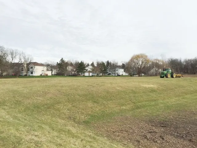 a view of a field with an ocean view
