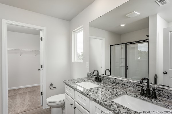 28 Rider Street Broadway, NC 27505 - Photo 20 of 22 a bathroom with a granite countertop sink a toilet and a large mirror
