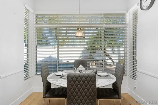 a view of a dining room with furniture and window