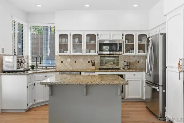 a kitchen with stainless steel appliances granite countertop a stove and a refrigerator