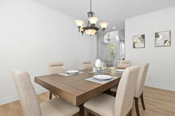 a view of a dining room with a table and chairs
