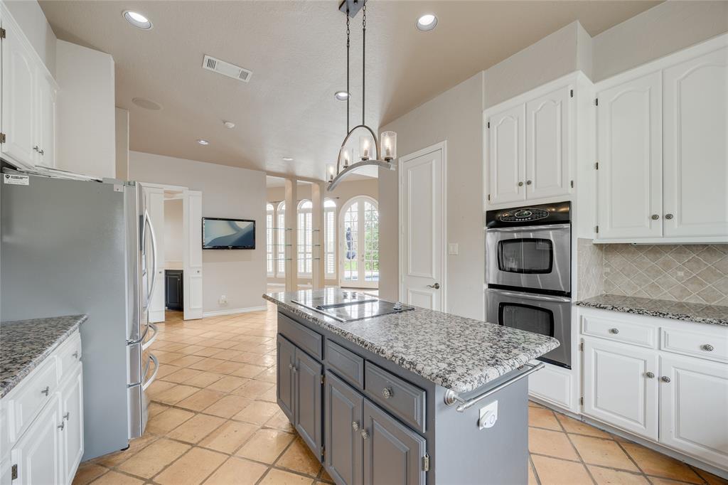 1201 Findlay Drive Arlington, TX 76012 - Photo 16 of 35 a kitchen with stainless steel appliances granite countertop a sink a stove and a refrigerator