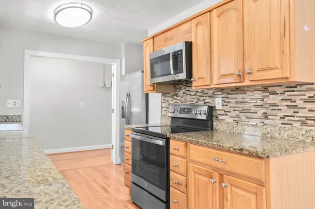 an aerial view of a house with a yard and lake view