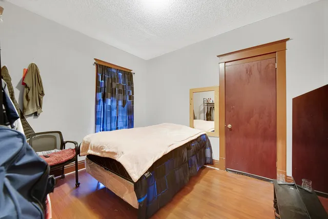 a bed room with a bed and a chair