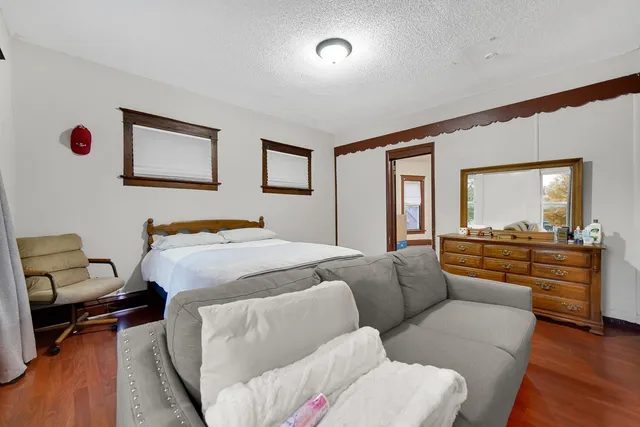 a bedroom with furniture and a wooden floor