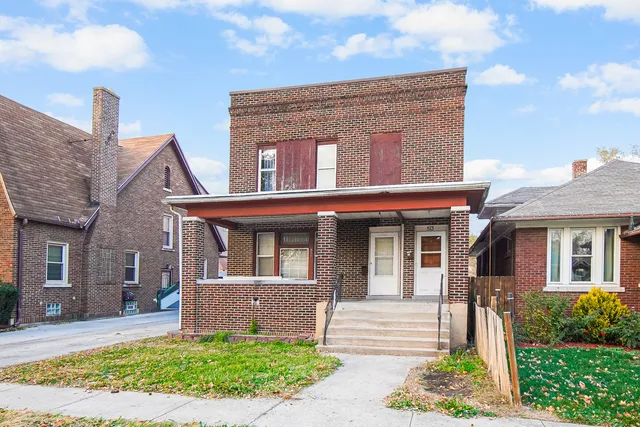 a front view of a house with garden