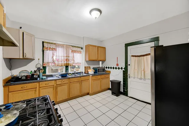 a kitchen with a refrigerator and a sink
