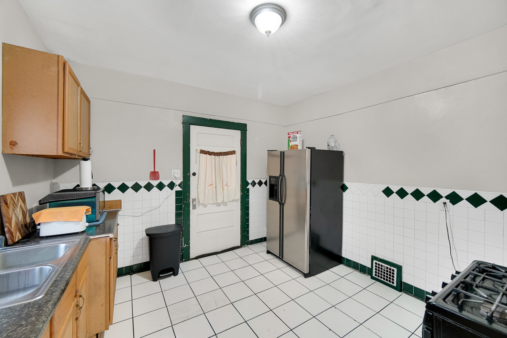 511 3rd Avenue Joliet, IL 60433 - Photo 23 of 30 a kitchen with a refrigerator and cabinets