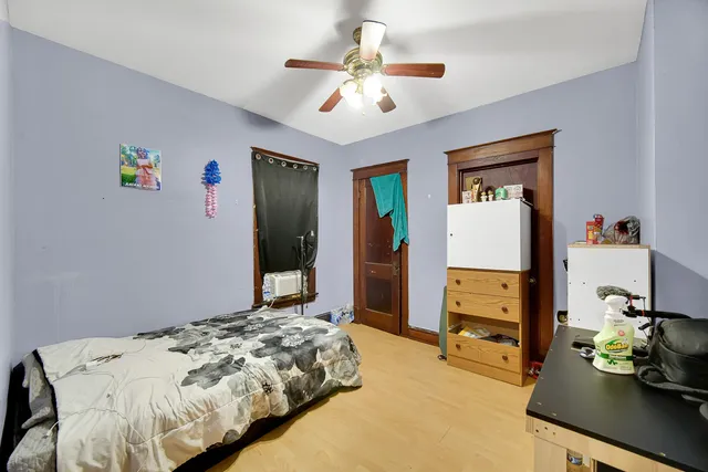 a bedroom that has a bed and a chandelier
