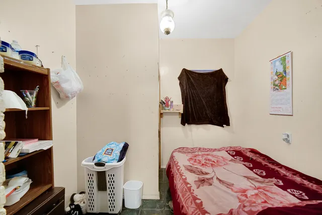 a bedroom with a bed and a television