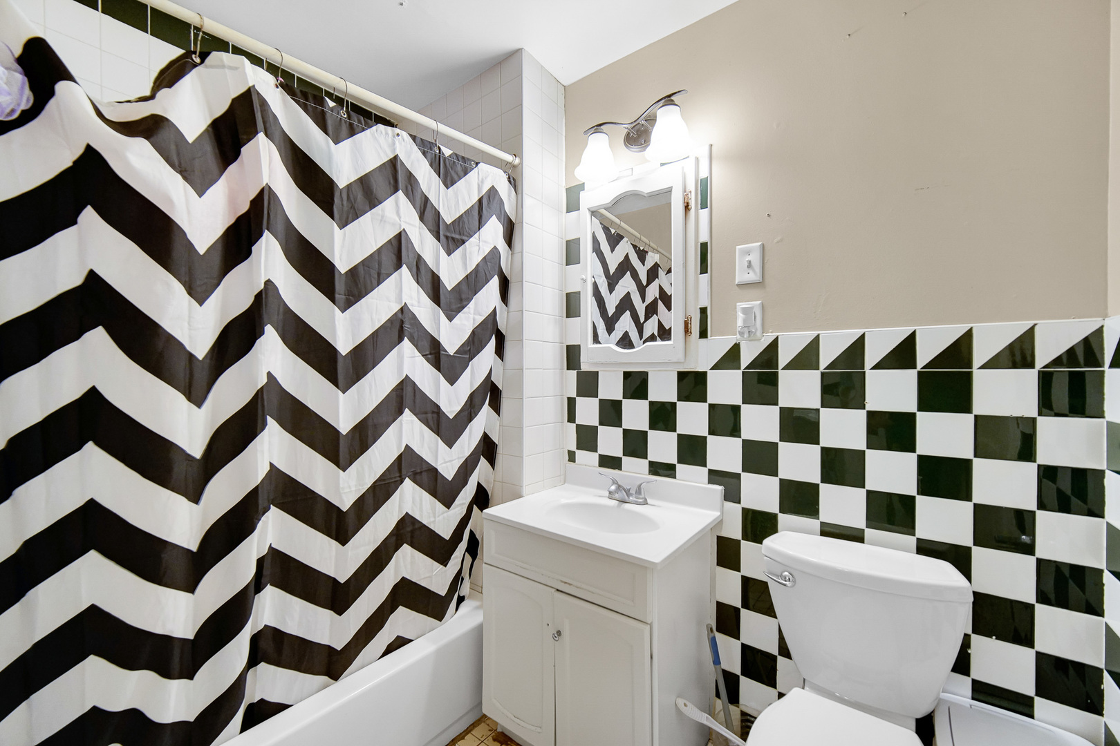 511 3rd Avenue Joliet, IL 60433 - Photo 27 of 30 a bathroom with a sink a toilet and a mirror