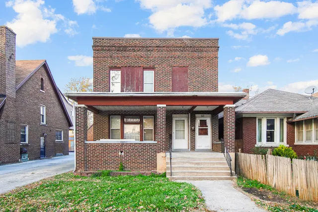 a front view of a house with a garden