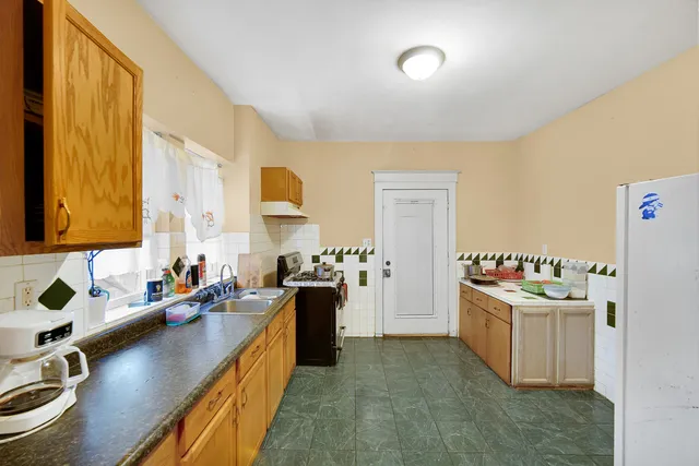 a kitchen with a sink stove and refrigerator