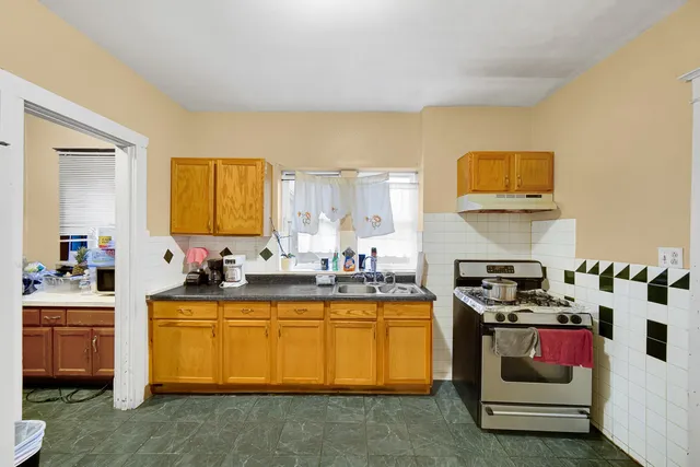 a kitchen with a sink stove and cabinets