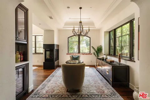 a living room with furniture a window and a chandelier