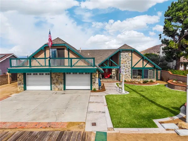 a front view of a house with yard and green space