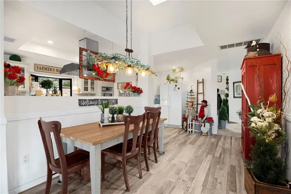 a kitchen with stainless steel appliances kitchen island granite countertop a refrigerator and a stove top oven