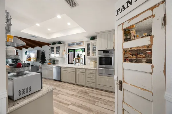 a kitchen with stainless steel appliances sink microwave and cabinets