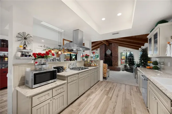 a kitchen with lots of counter top space and wooden floor